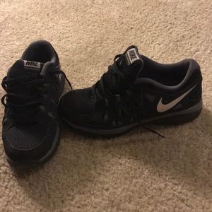 Kids black and grey Nike athletic shoes